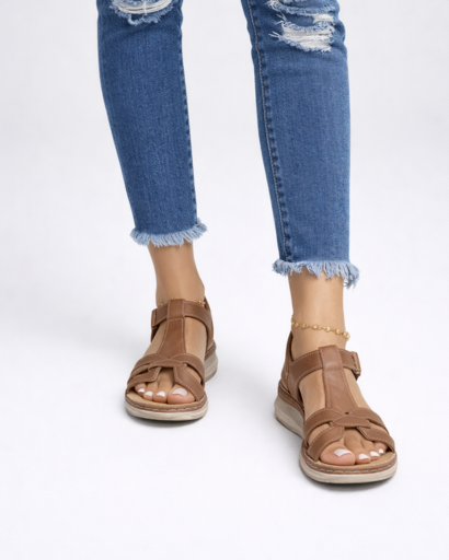 Women’s flat sandals with criss-cross straps, adjustable ankle strap, and wedge sole